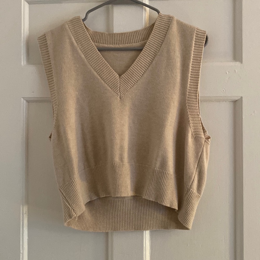 Cream sweater vest.